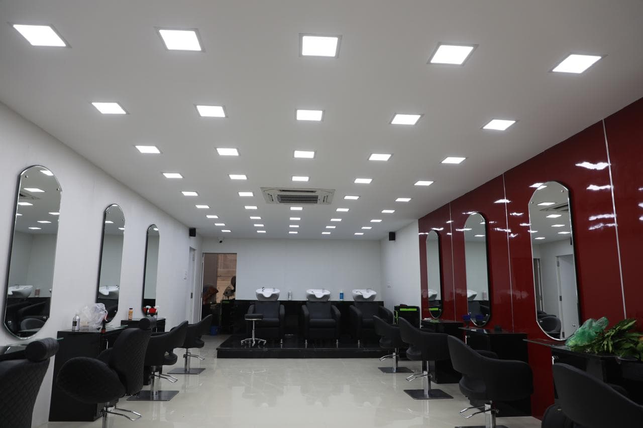 Wash bays at HOP Salon with reclining basins set against the red feature wall