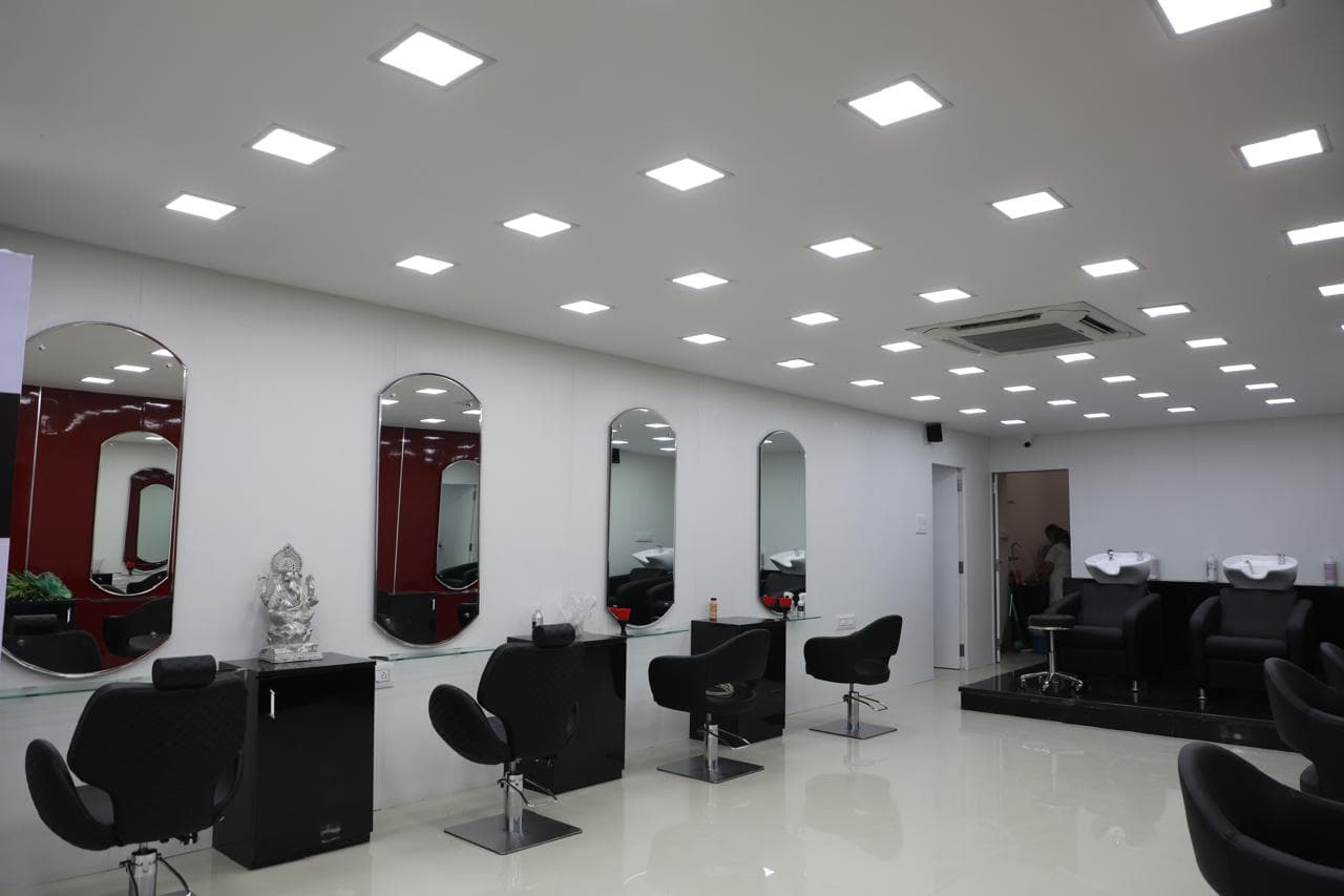 Styling stations with arched mirrors along a white wall at HOP Salon